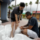 Shipowners place sandbags in front of their Daytona Beach store to protect against flooding. Image: AP